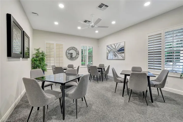 Dining space with recessed lighting, light colored carpet, and ceiling fan