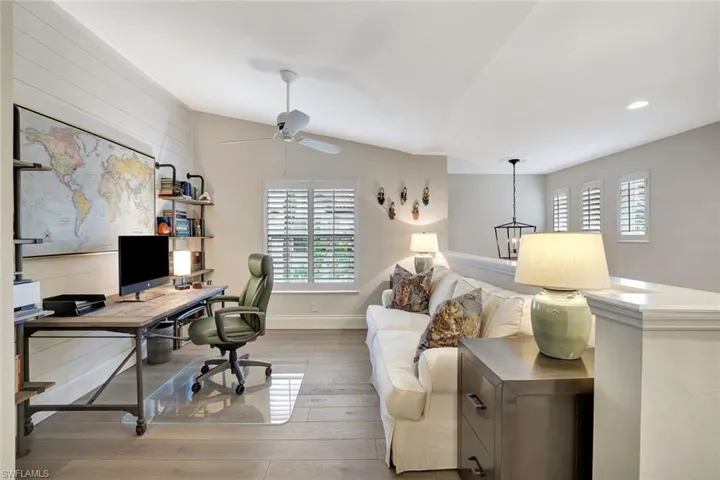 Den-Office with ample space for a sleeper sofa, plantation shutters on windows.