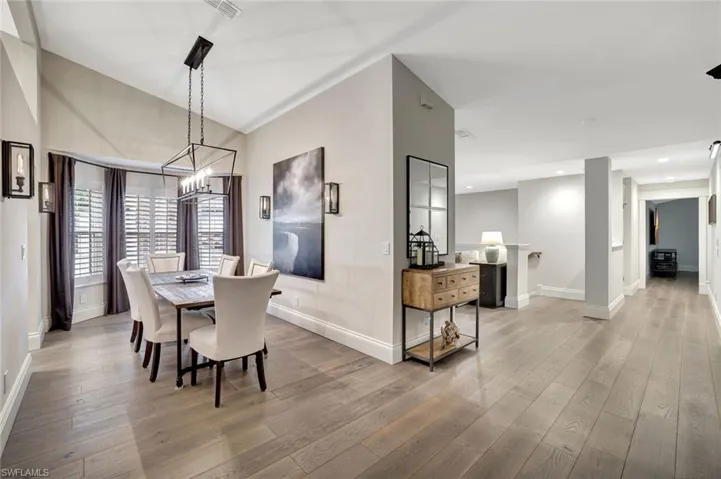 Dining area with bay window, 4 wall sconces and lovely chandelier