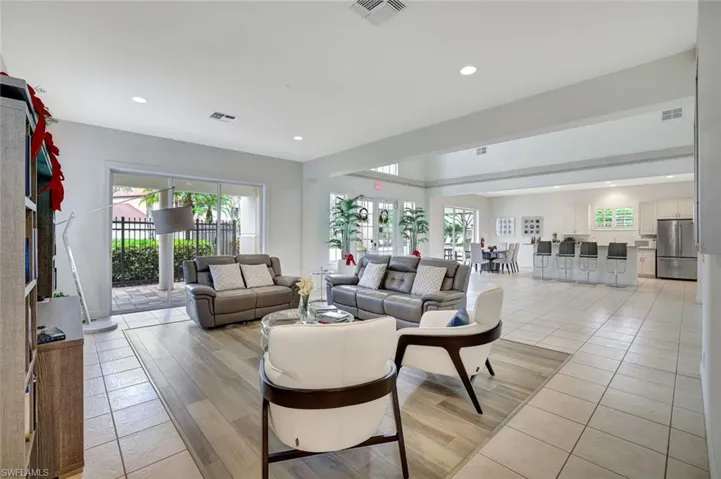 Living room featuring light wood-style floors, healthy amount of natural light, and recessed lighting
