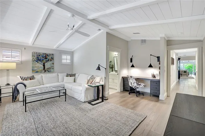 3rd bedroom currently used as media room w/vaulted beamed ceilings, ensuite bath, designated closet area has a built-in desk (could easily be converted back to a closet).
