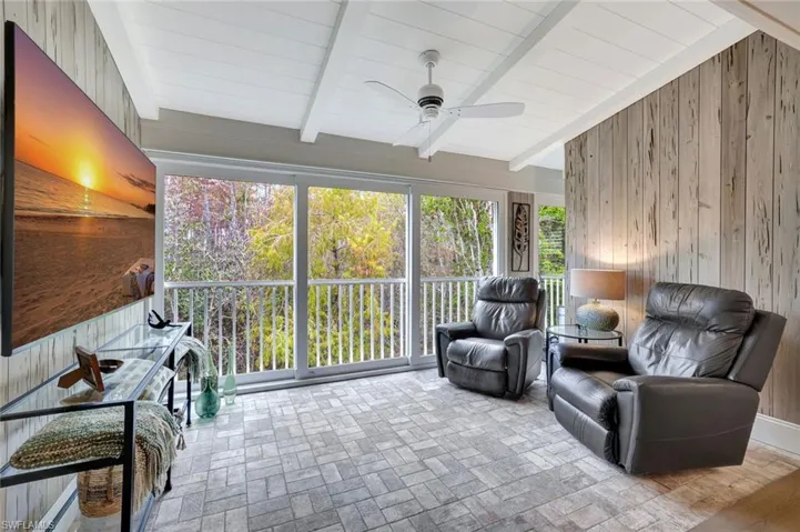 Club Room with Pecky Cypress walls, brick tile flooring. Fabulous preserve views. Vaulted shiplap/beam ceiling treatments