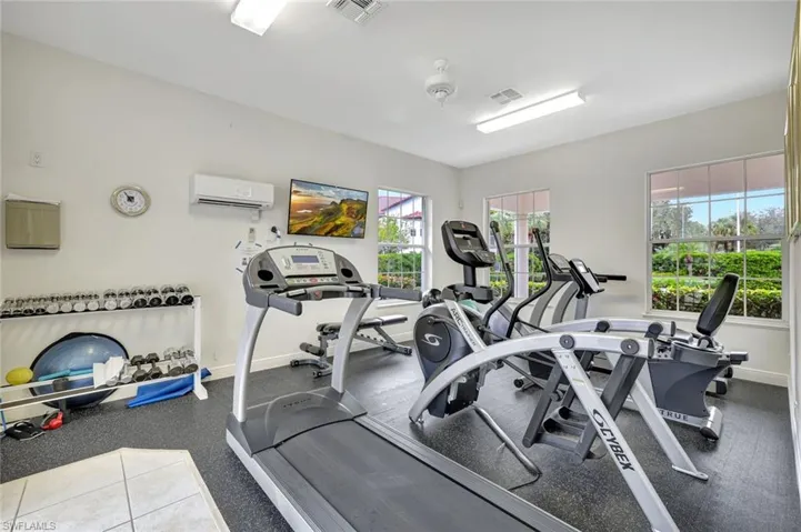 Exercise room featuring a wall unit AC