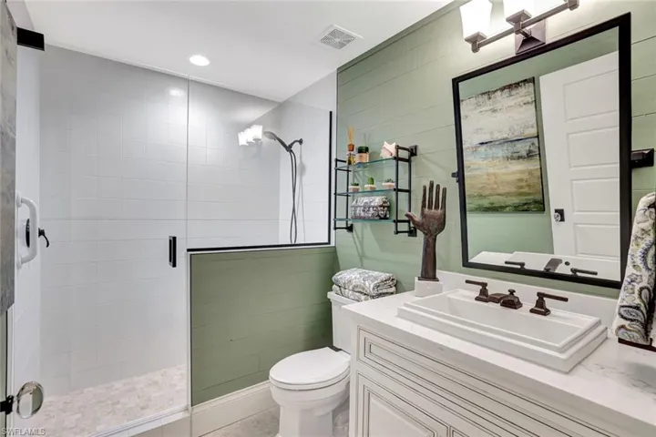 Full bath featuring vanity, a shower stall, and recessed lighting