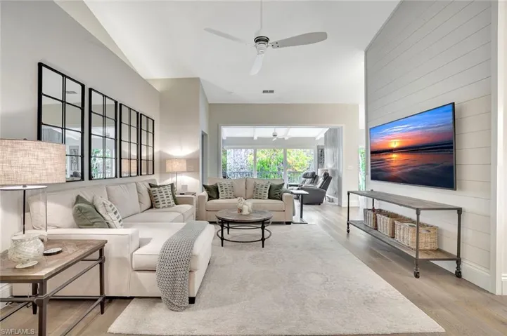 Great Room Featuring reclaimed wood flooring with volume ceilings