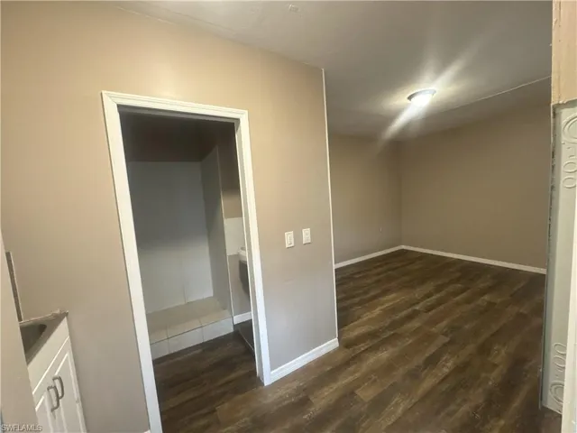 Efficency with baseboards and dark wood-type flooring