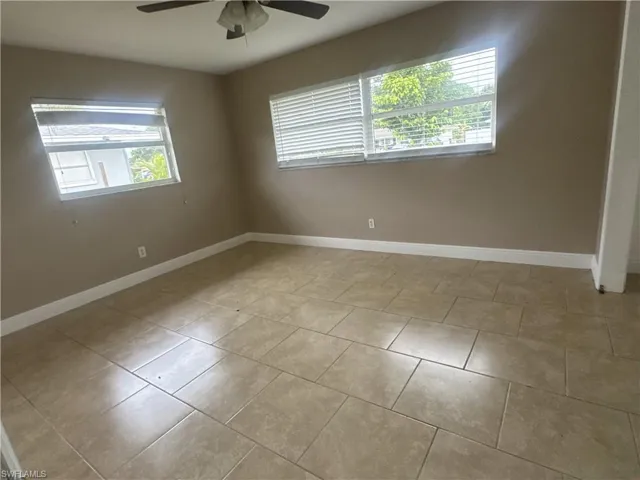 Spare room with plenty of natural light and light tile patterned flooring
