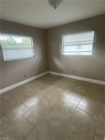 Unfurnished bedroom featuring a closet and tile patterned floors