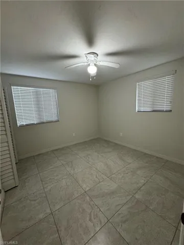 Empty room with baseboards and ceiling fan