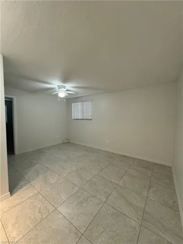Spare room featuring ceiling fan and a textured ceiling