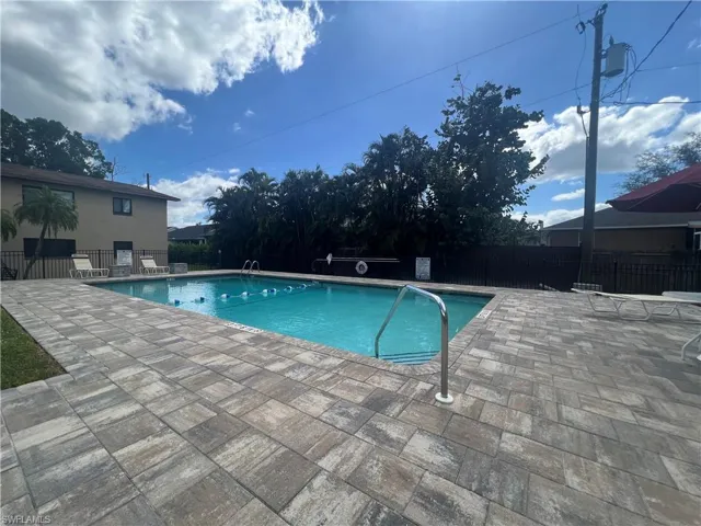 Community pool with a patio