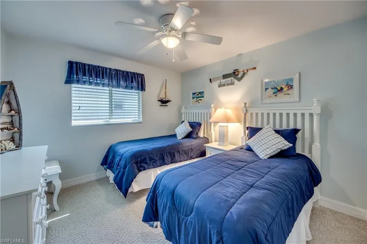 Carpeted bedroom with ceiling fan