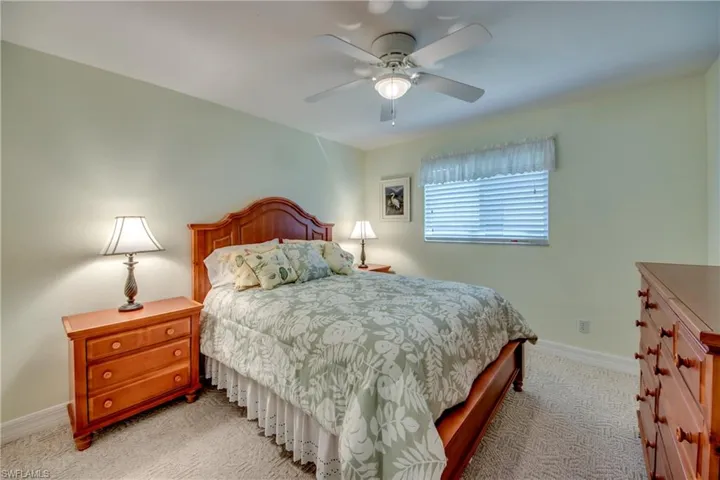 Carpeted bedroom with ceiling fan