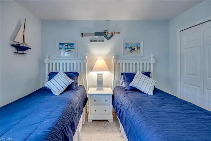 Carpeted bedroom with a closet