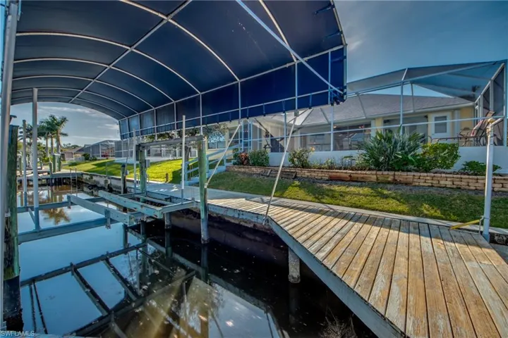 Dock area with glass enclosure and a lawn