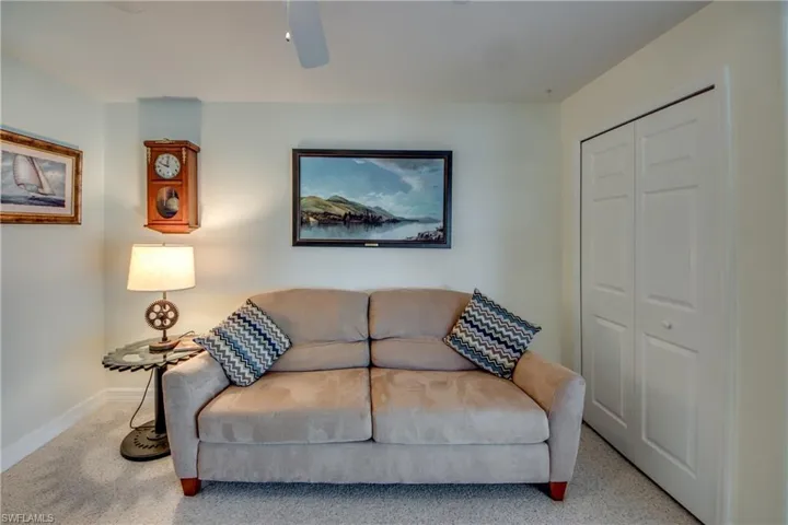 Living room featuring light carpet and ceiling fan