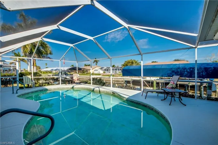 View of swimming pool featuring a lanai and a patio area