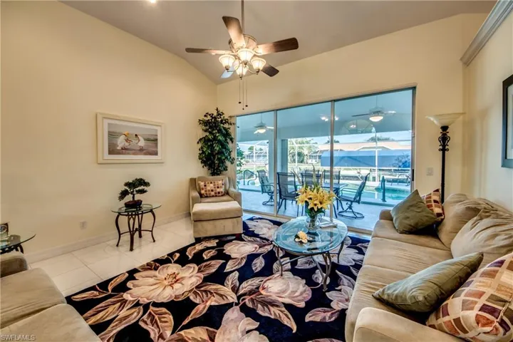 Tiled living room with lofted ceiling
