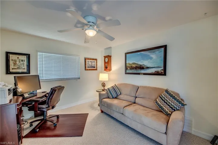 Carpeted office space with ceiling fan