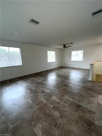 Multi-use second floor den/family room/play room leads to second floor deck