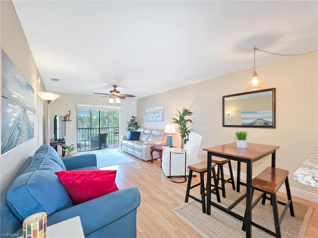 Living room with light wood-type flooring and ceiling fan