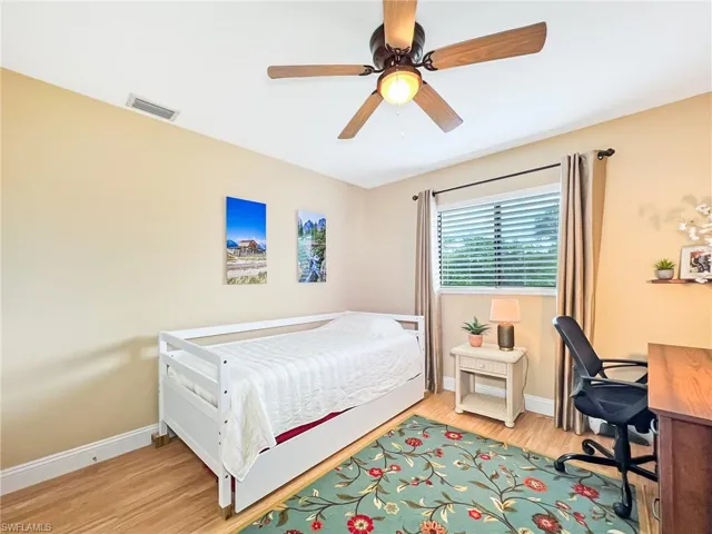 Bedroom featuring light hardwood / wood-style floors and ceiling fan