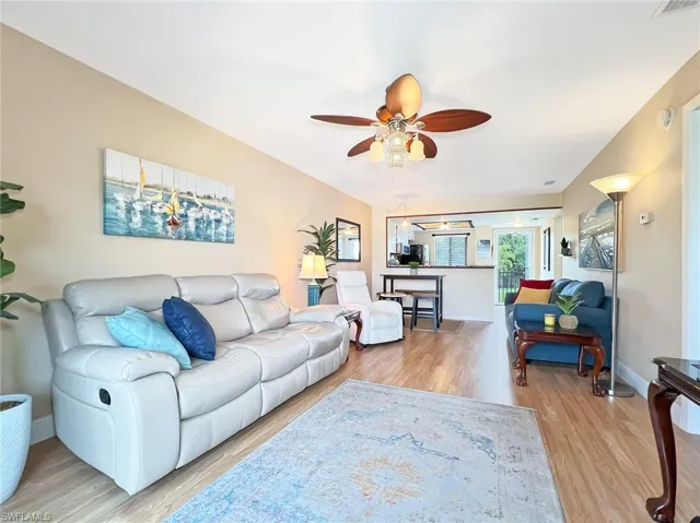Living room featuring ceiling fan and hardwood / wood-style floors