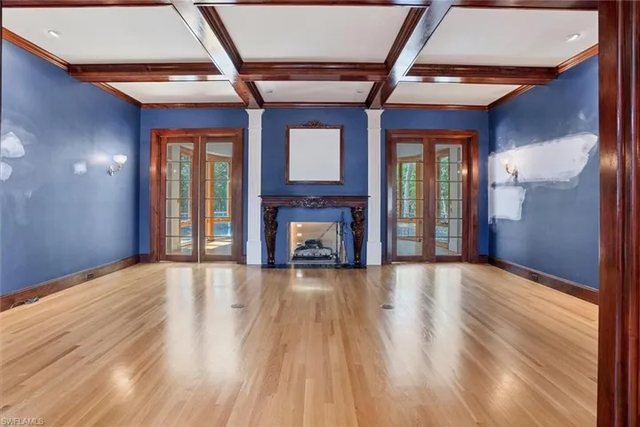 Formal Living Area with Double Sided Gas Fireplace and Double Doors to the Sunroom