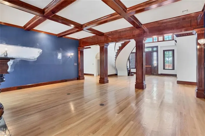 Formal Living Area with Spectacular Wood Beams and a View of the Front Entry Area
