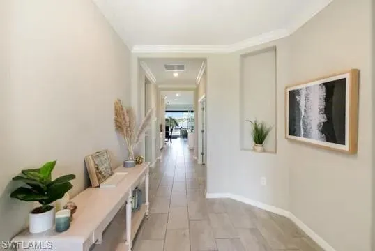 Hallway featuring crown molding