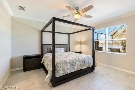 Bedroom with ornamental molding and ceiling fan
