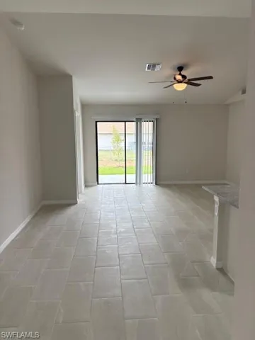 Spare room with baseboards and ceiling fan