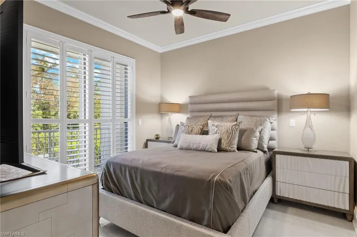 Bedroom with ceiling fan and ornamental molding