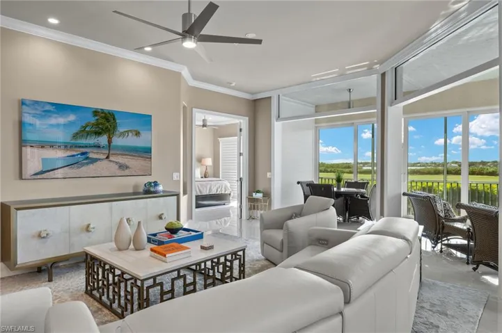 Kitchen featuring stainless steel appliances, kitchen peninsula, sink, a kitchen breakfast bar, and a tray ceiling