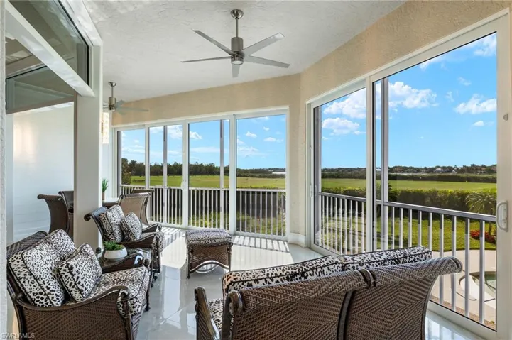 Sunroom featuring ceiling fan