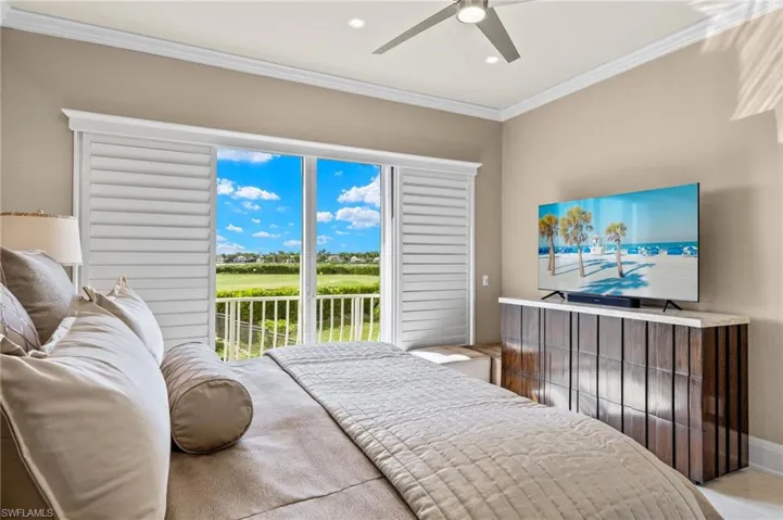 Bedroom featuring access to outside, ceiling fan, and crown molding