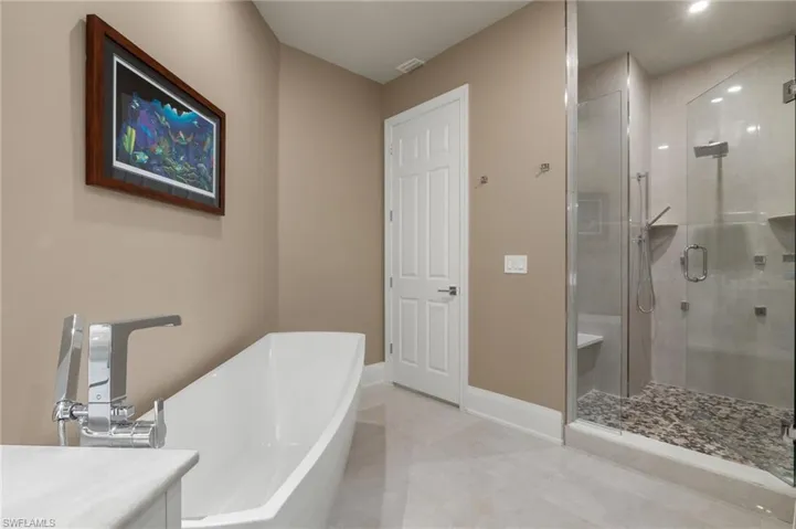 Bathroom featuring vanity and plus walk in shower