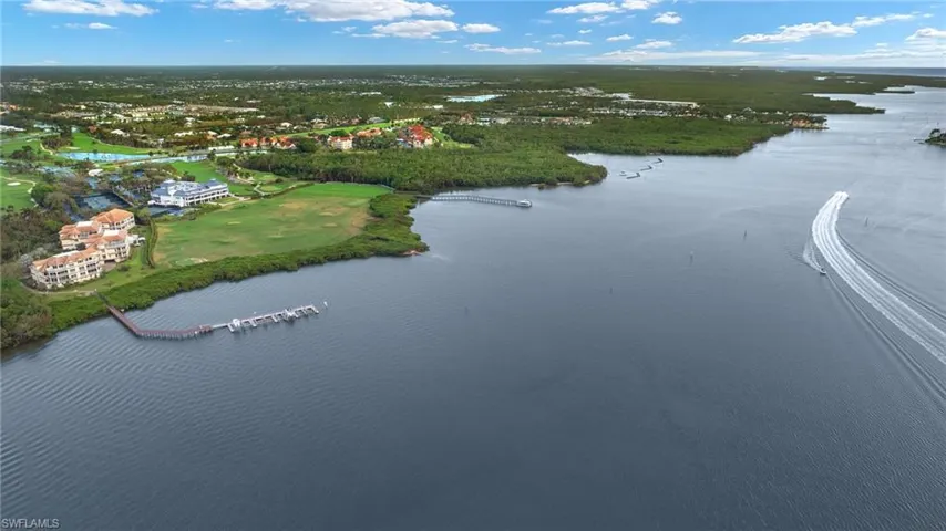 Birds eye view of property with a water view