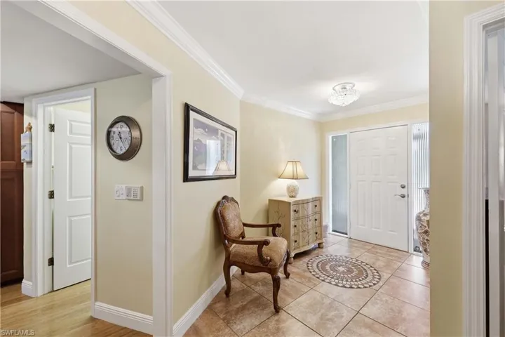 Foyer entrance with ornamental molding and light tile patterned floors