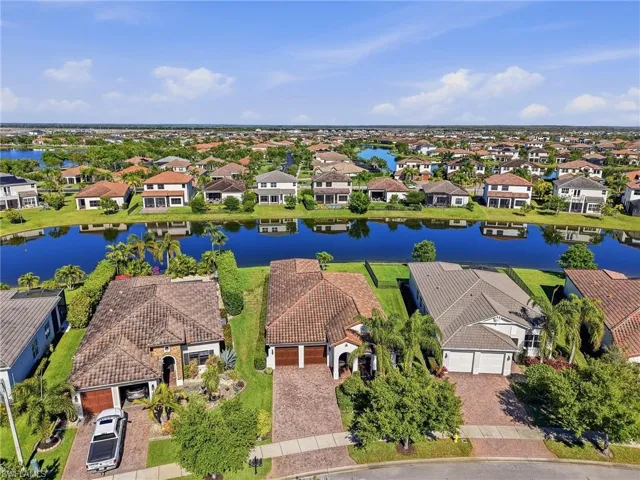 Aerial view showcasing the property's location within a community featuring numerous waterways and a vast expanse of residential properties