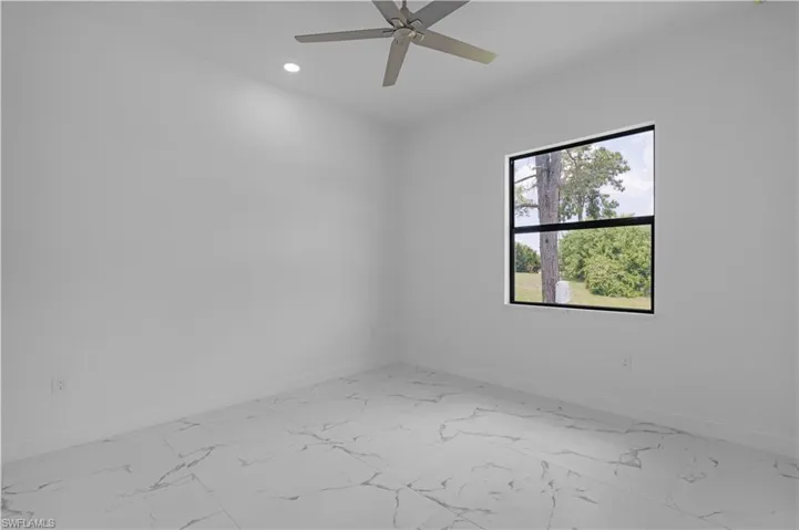 Spare room featuring light marble finish flooring, recessed lighting, and a ceiling fan