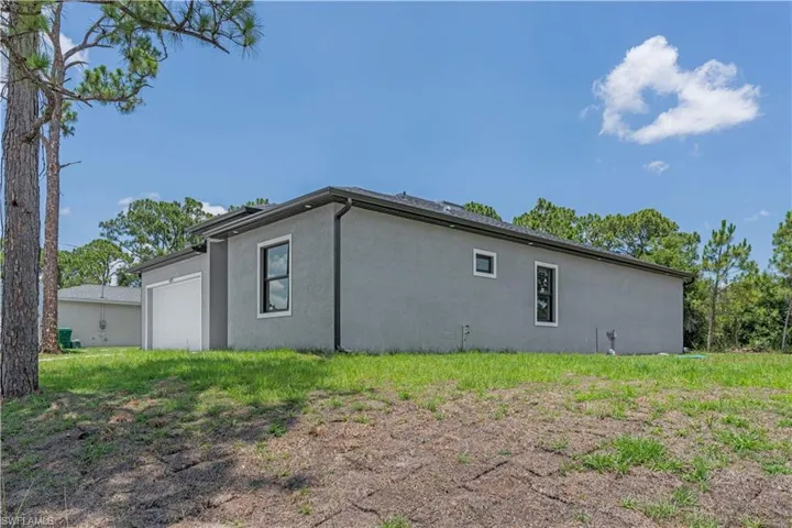 View of property exterior featuring stucco siding and a garage