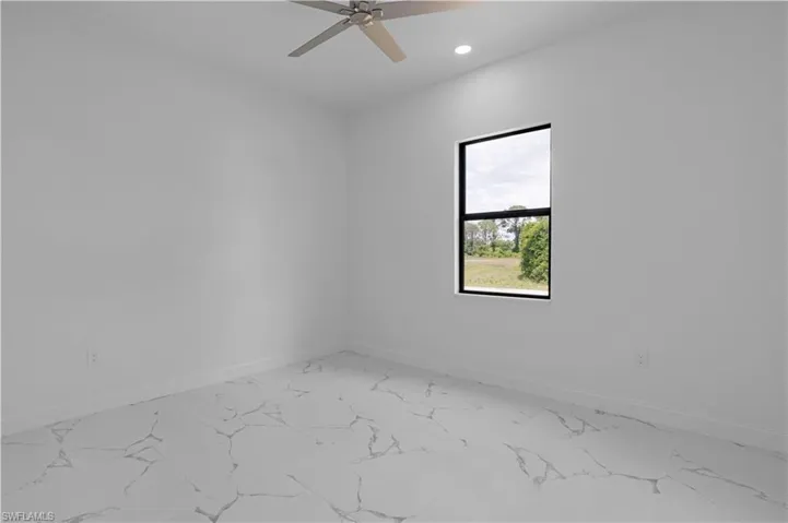 Unfurnished room with light marble finish floors, recessed lighting, and a ceiling fan