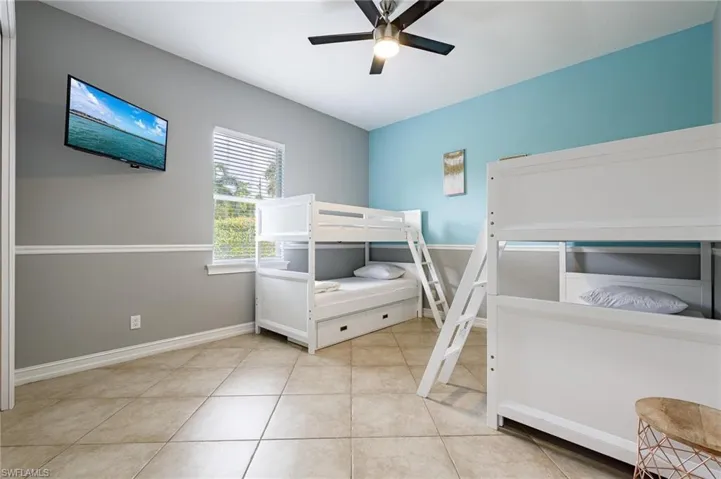 Bedroom featuring ceiling fan and light tile patterned flooring