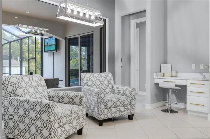 Sitting room featuring a sunroom and light tile patterned floors