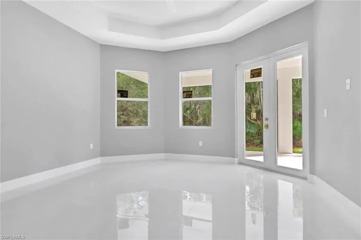 Unfurnished room featuring a tray ceiling