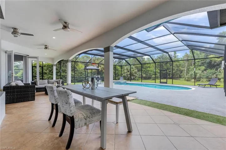 View of patio / terrace with an outdoor hangout area, an outdoor pool, ceiling fan, a lanai, and a sunroom