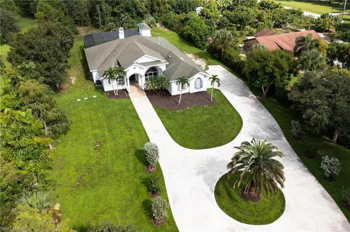 View from above of property with a tree filled landscape