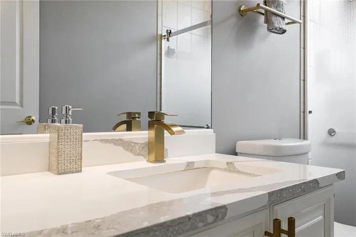 Bathroom featuring vanity and a shower with door