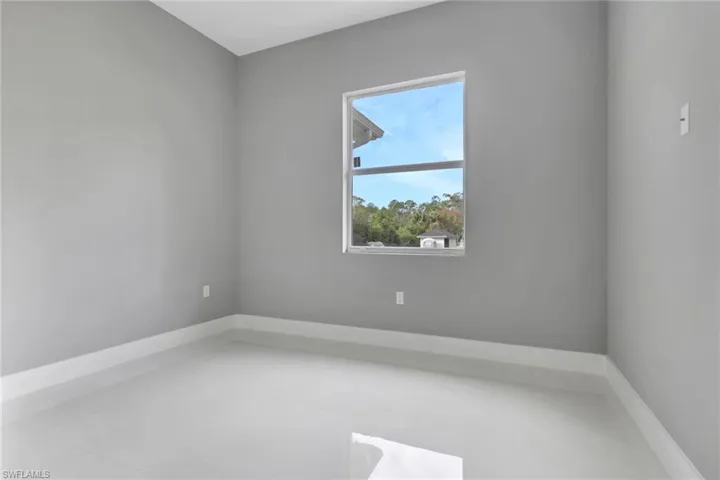 Unfurnished room featuring baseboards